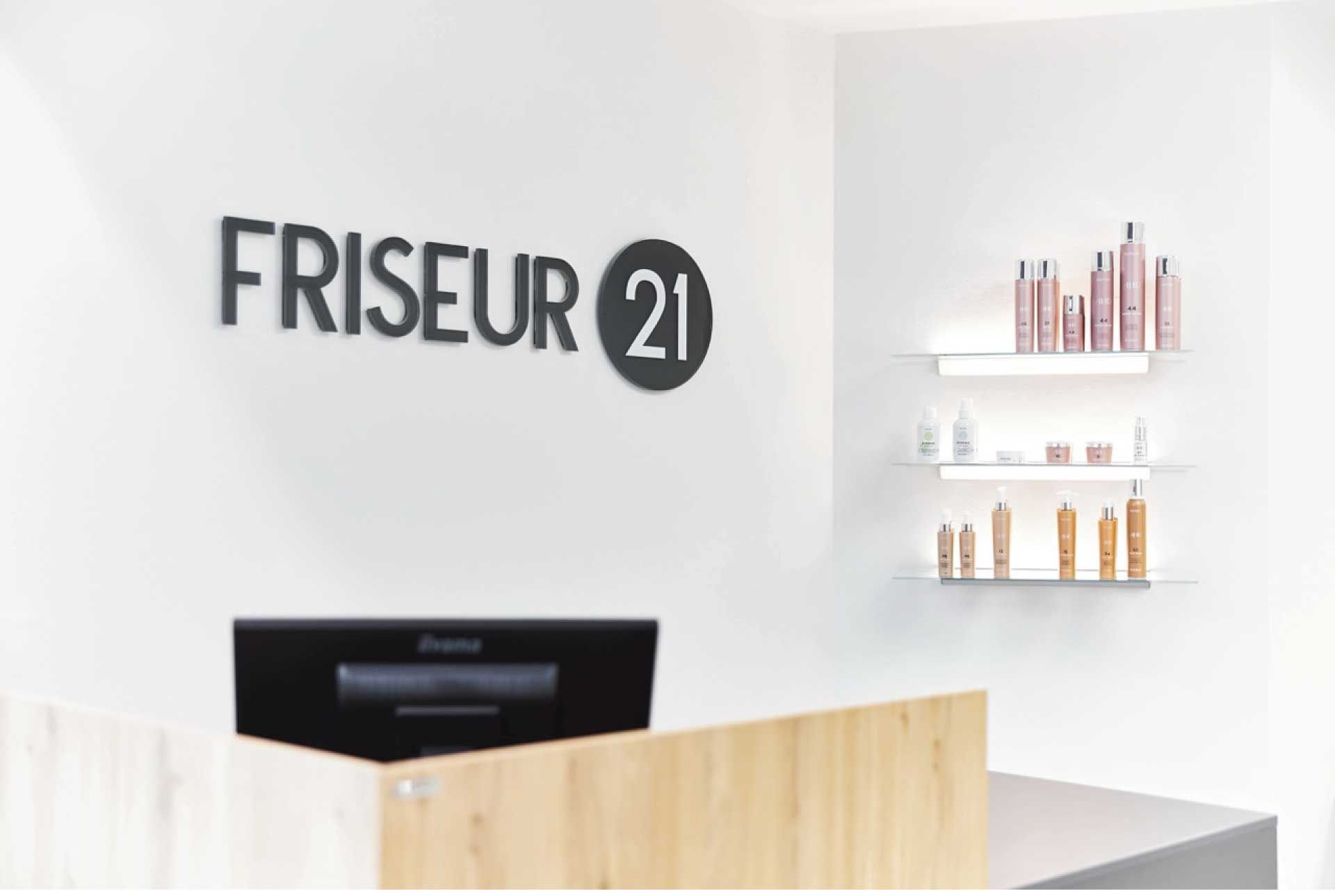 Friseur 21 Logo vor Tresen mit Produktregal